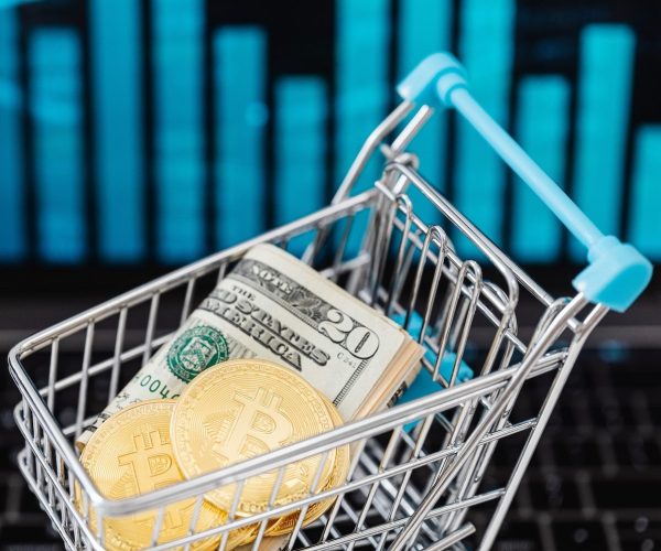 Gold Bitcoin Coins and Cash in a Miniature Shopping Cart