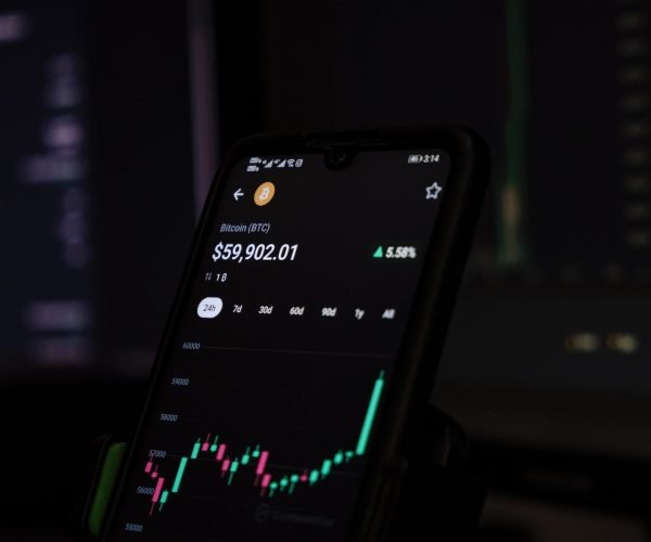 a cell phone displaying a stock chart on the screen